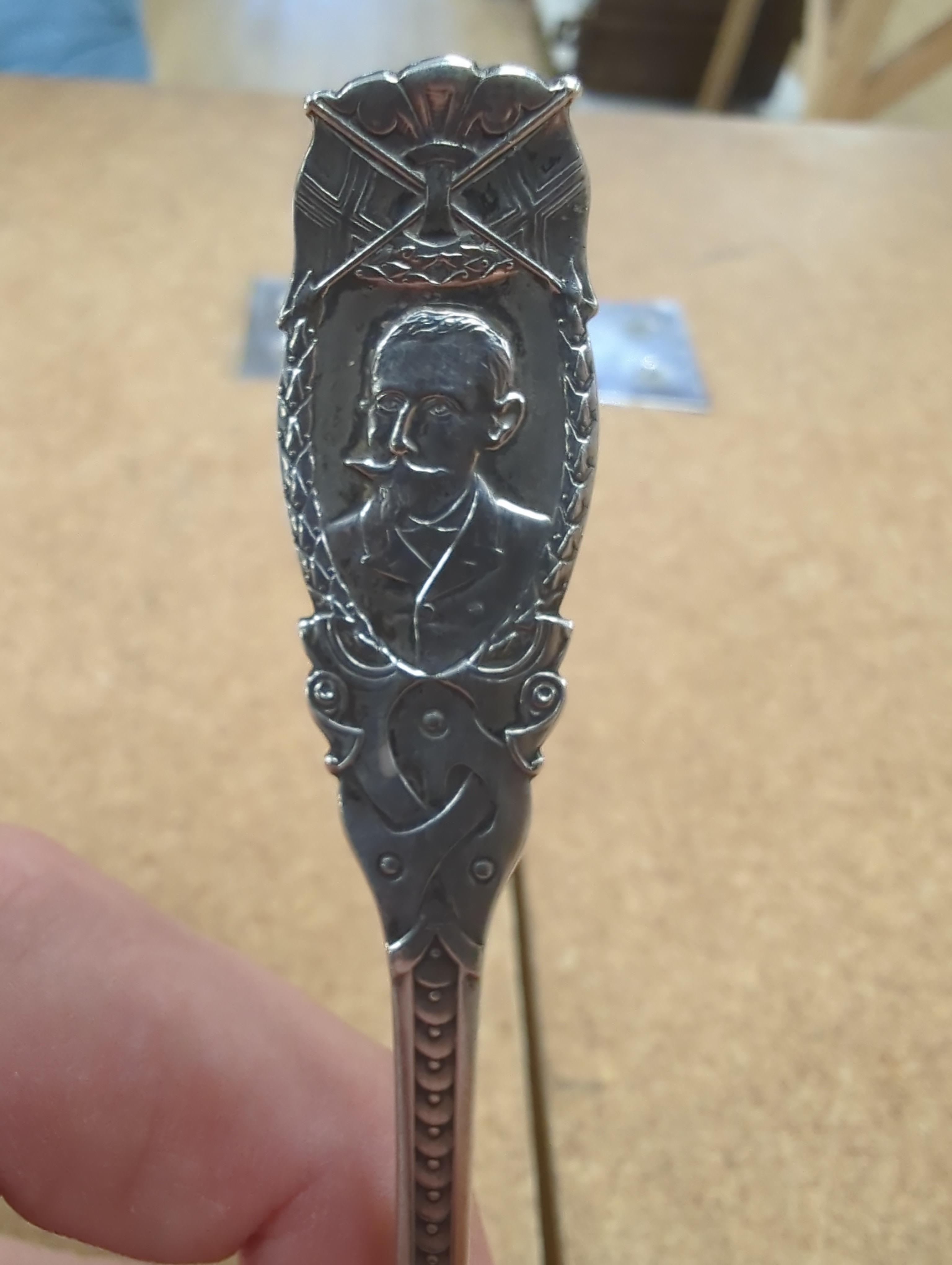 A Roald Amundsen commemorative .830 silver spoon, circa 1911, and five other commemorative spoons, of which four are silver including; Royal Military College, Small Arms School, Royal Army Service Corps, The Kensingtons